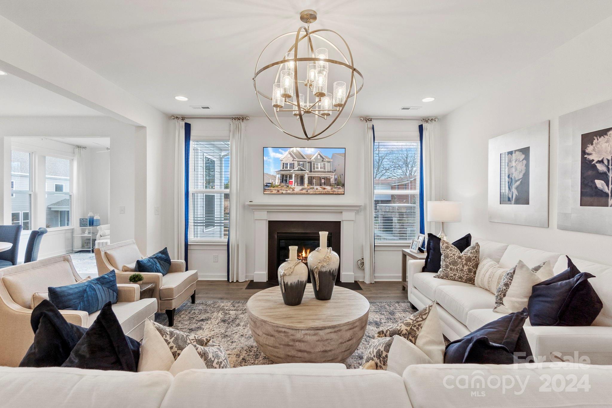 13228 Chopin Ridge Road Huntersville, NC 28078 - Photo 17 of 37 a living room with furniture a fireplace and a chandelier