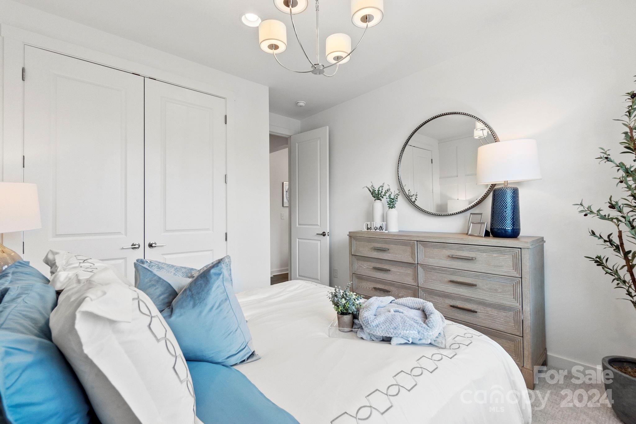 13228 Chopin Ridge Road Huntersville, NC 28078 - Photo 20 of 37 a bed room with a bed a mirror and lamp
