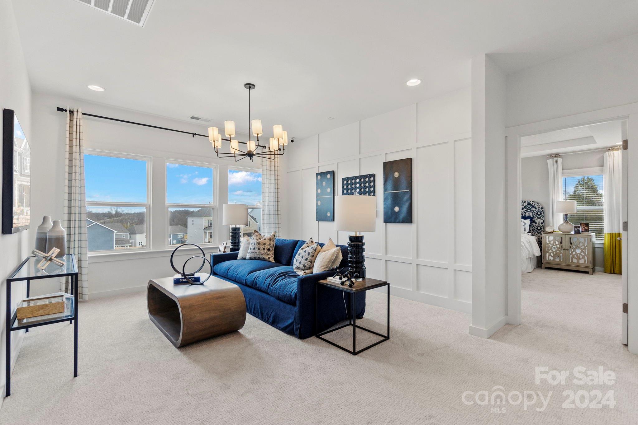 13228 Chopin Ridge Road Huntersville, NC 28078 - Photo 22 of 37 a living room with furniture chandelier and a chandelier