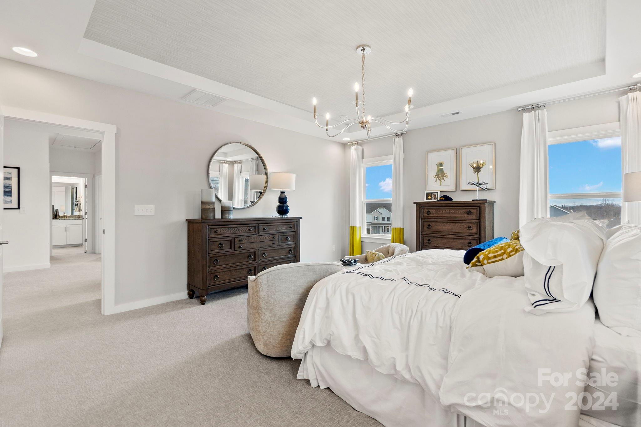 13228 Chopin Ridge Road Huntersville, NC 28078 - Photo 24 of 37 a spacious bedroom with a bed a dresser and wooden floor