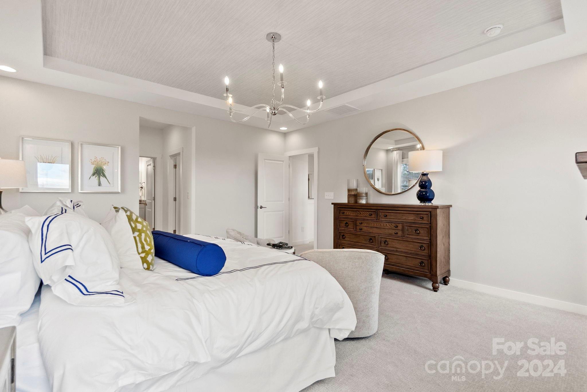 13228 Chopin Ridge Road Huntersville, NC 28078 - Photo 25 of 37 a bedroom with a bed and a chandelier