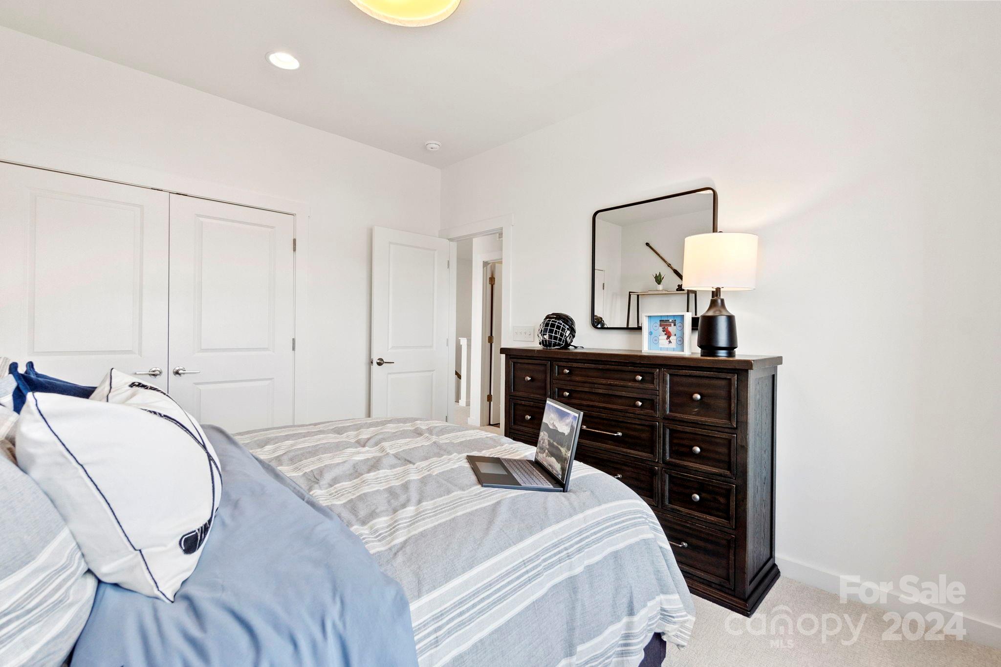 13228 Chopin Ridge Road Huntersville, NC 28078 - Photo 31 of 37 a bedroom with a bed and a dresser