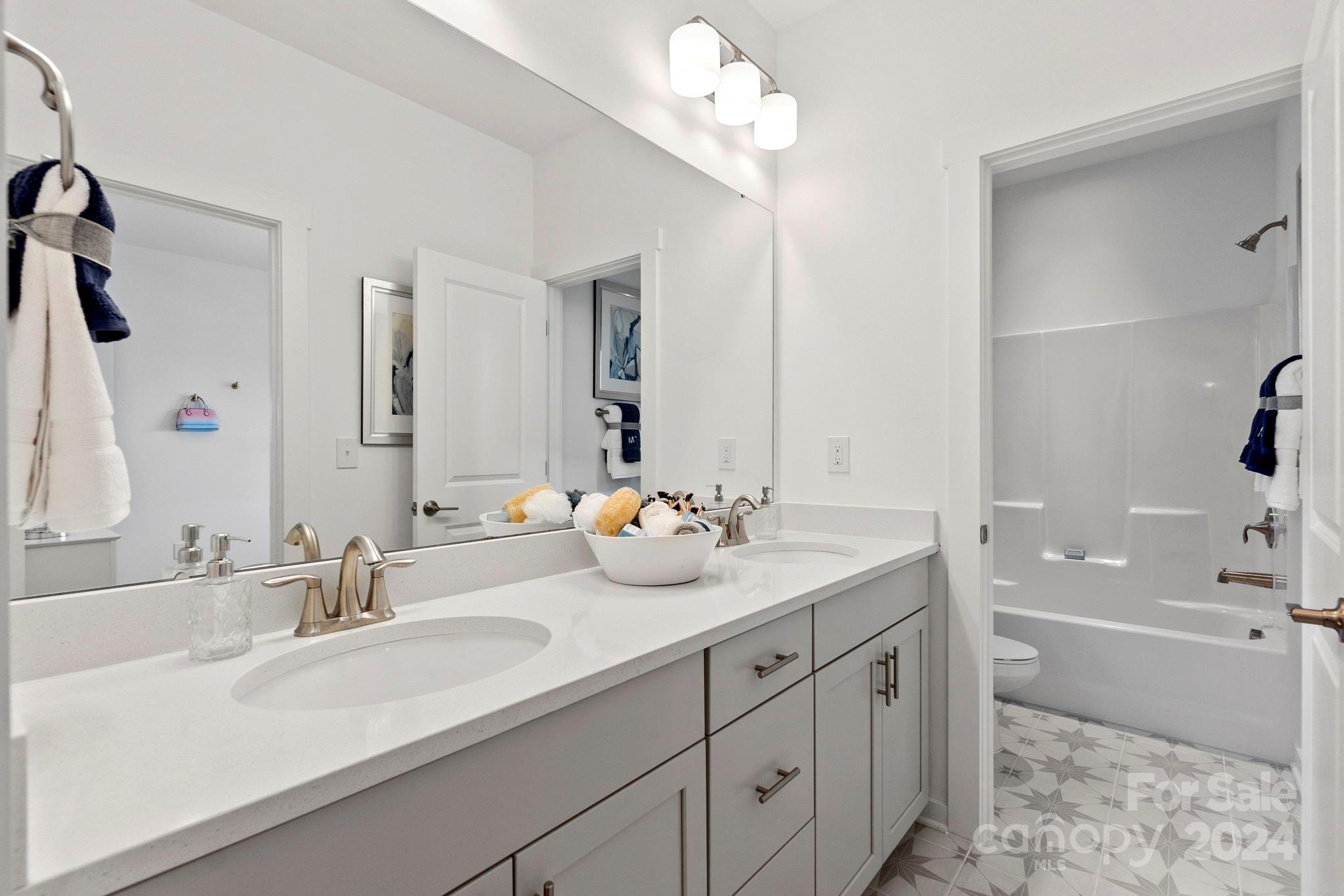 13228 Chopin Ridge Road Huntersville, NC 28078 - Photo 35 of 37 a bathroom with a sink double vanity granite tub and shower