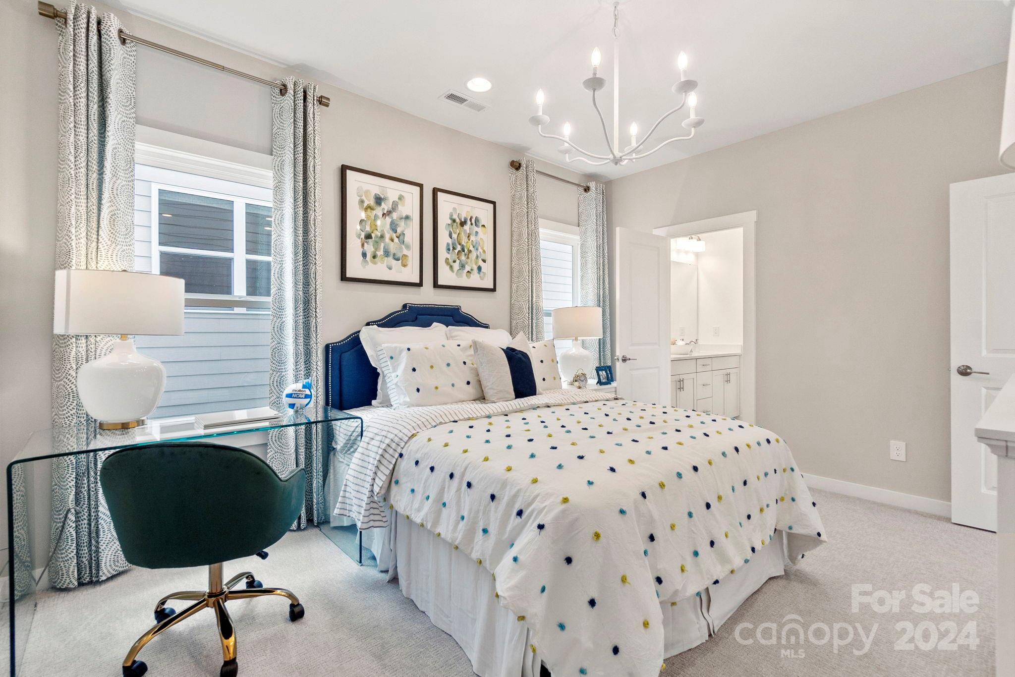 13228 Chopin Ridge Road Huntersville, NC 28078 - Photo 37 of 37 a bedroom with a bed and a chandelier