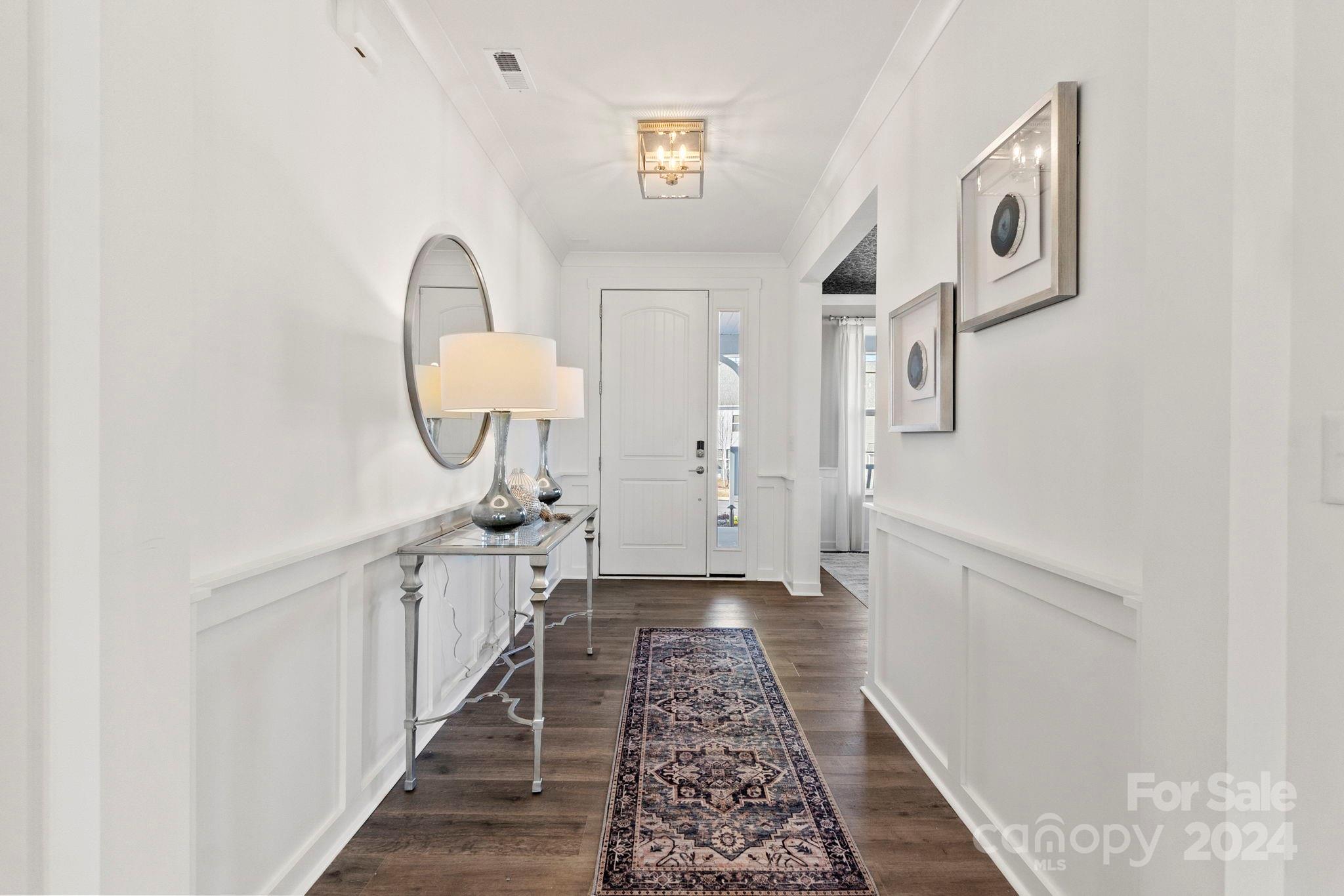13228 Chopin Ridge Road Huntersville, NC 28078 - Photo 5 of 37 a view of a hallway to a livingroom with furniture