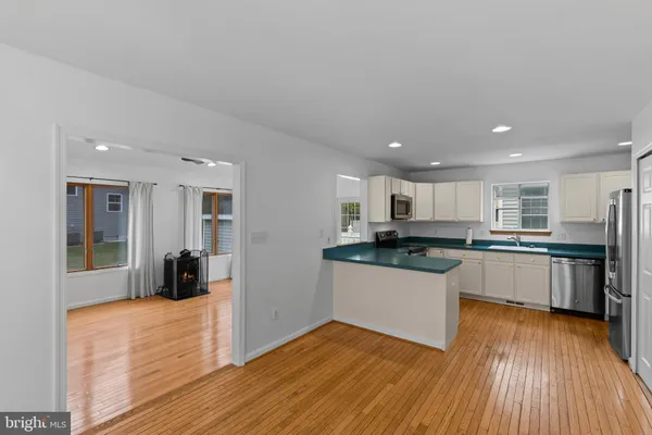 a kitchen with stainless steel appliances granite countertop a refrigerator a sink and a stove