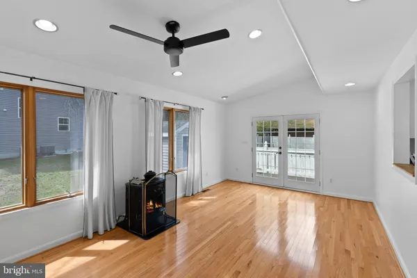 a view of a room with wooden floor and windows