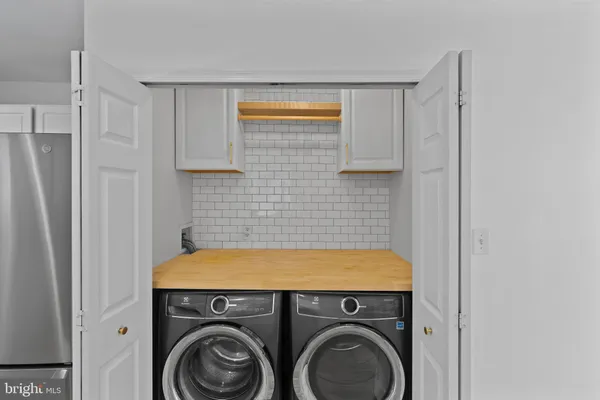 a view of storage and utility room with washer and dryer