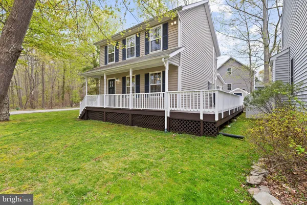 a view of a house with a yard and sitting area