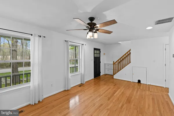 a view of a bedroom with a bed and a window