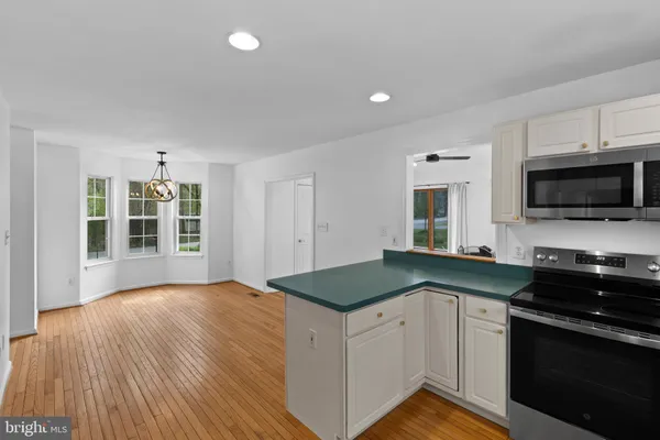 a kitchen with granite countertop a stove and a sink
