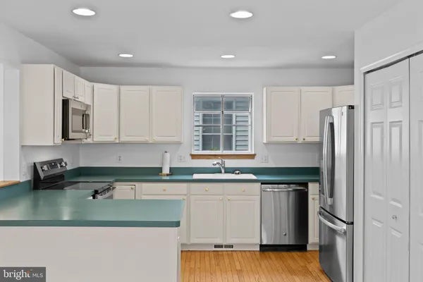 a kitchen with stainless steel appliances granite countertop a refrigerator sink and cabinets