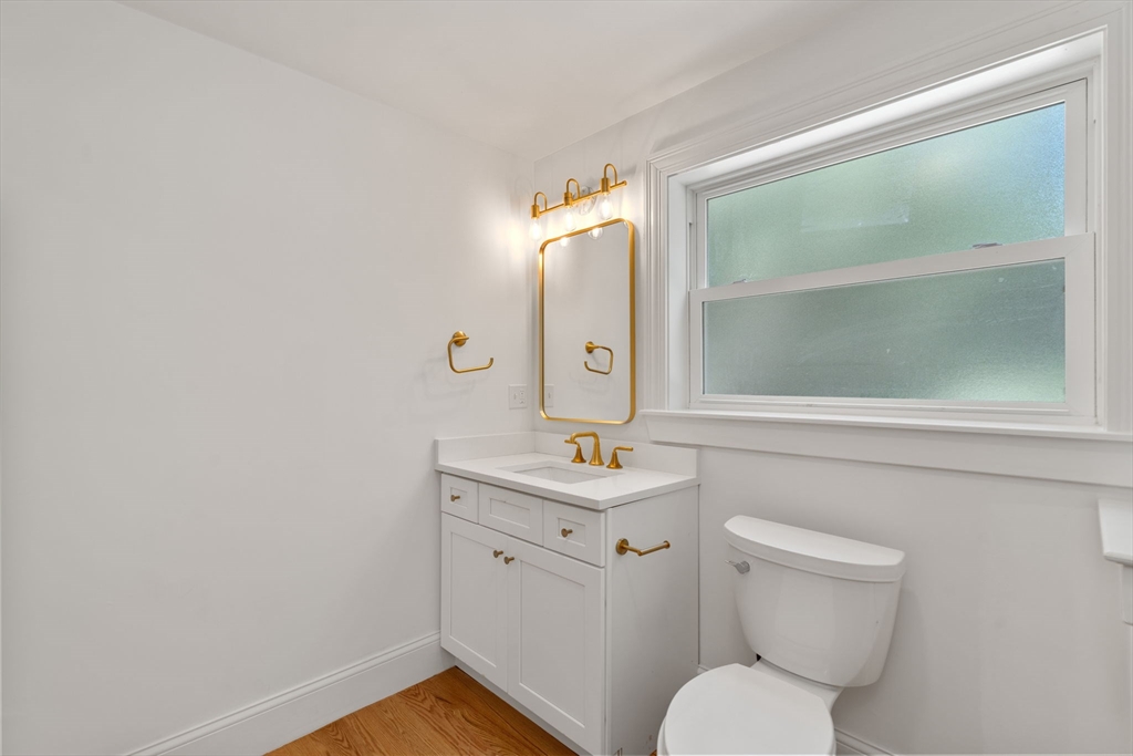 19 Brooks Road Gloucester, MA 01930 - Photo 12 of 32 a bathroom with a toilet sink and mirror