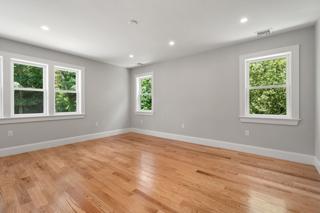 19 Brooks Road Gloucester, MA 01930 - Photo 14 of 32 an empty room with wooden floor and windows