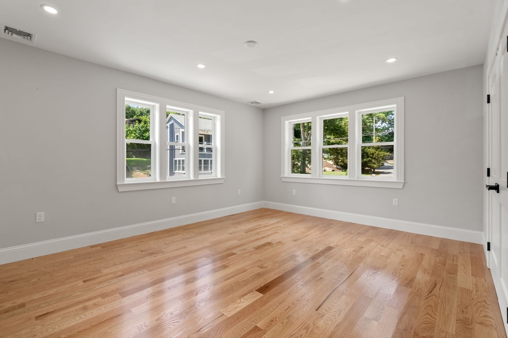 19 Brooks Road Gloucester, MA 01930 - Photo 15 of 32 a view of an empty room with wooden floor and windows