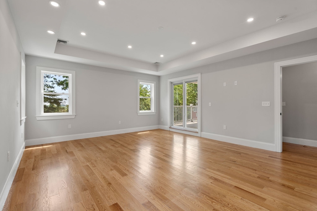 19 Brooks Road Gloucester, MA 01930 - Photo 20 of 32 an empty room with wooden floor and windows