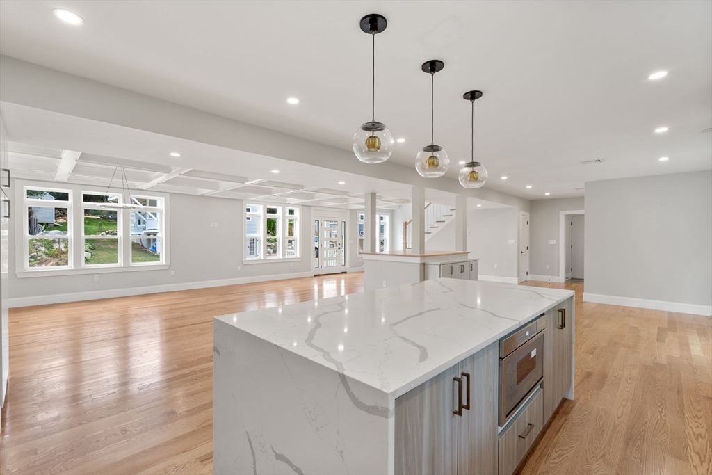 19 Brooks Road Gloucester, MA 01930 - Photo 7 of 32 a large kitchen with kitchen island a large island in it