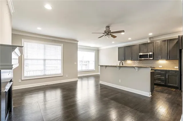 a view of a kitchen with a sink and a stove top oven