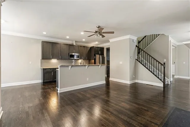 a view of a kitchen with wooden floor and a window