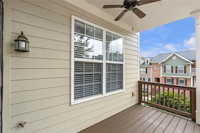 a view of a balcony with a potted plant and wooden floor