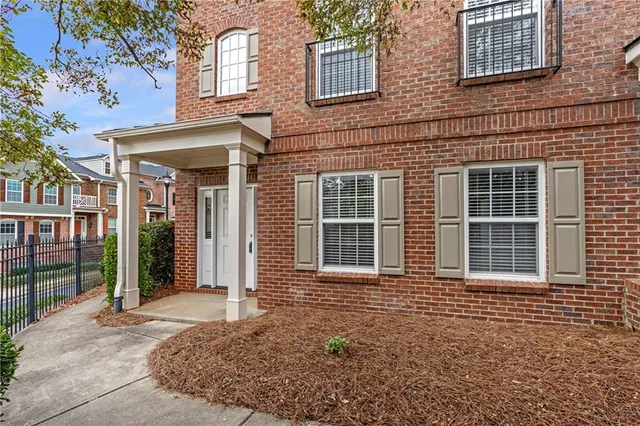 front view of a brick house with a large windows
