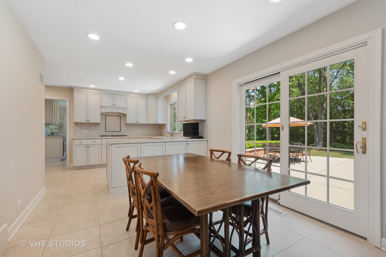 275 Old Mill Road Barrington, IL 60010 - Photo 7 of 45 a kitchen with stainless steel appliances granite countertop a stove a refrigerator a kitchen island a table and chairs in it