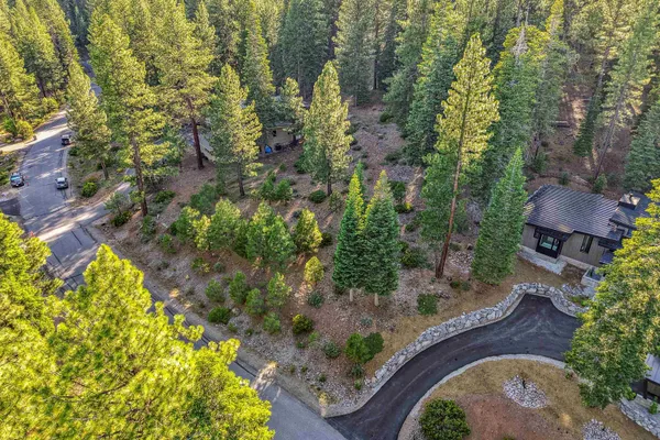 an aerial view of a house with a yard basket ball court and outdoor seating