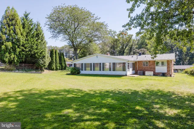 a living room with lots of furniture and a chandelier