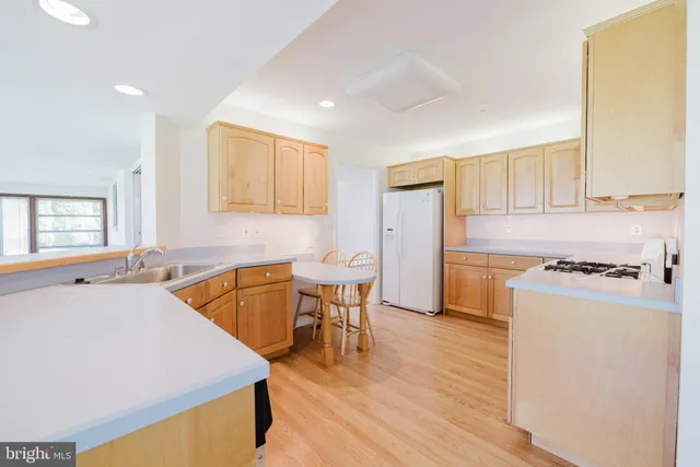 a kitchen with a stove top oven sink and cabinets