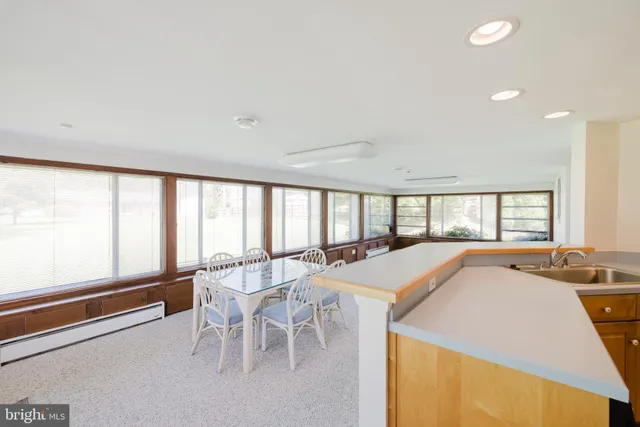 a kitchen with refrigerator a stove a sink and cabinets