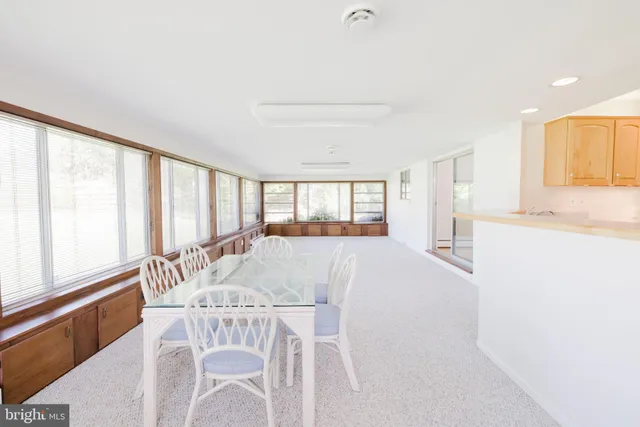 a view of a kitchen with a dining table and chairs