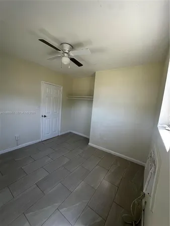 a kitchen with a refrigerator and cabinets