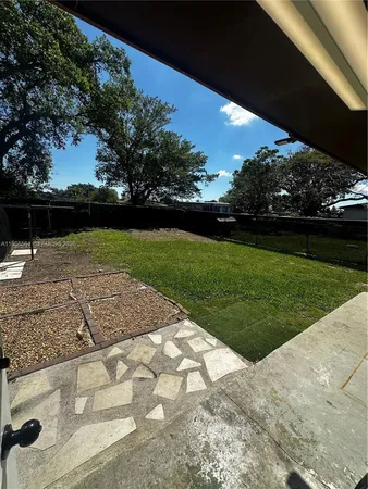 a view of a backyard of the house