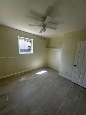 a view of an empty room and a window