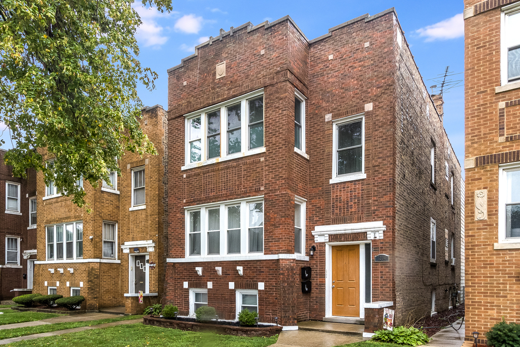 a front view of a building with a garden