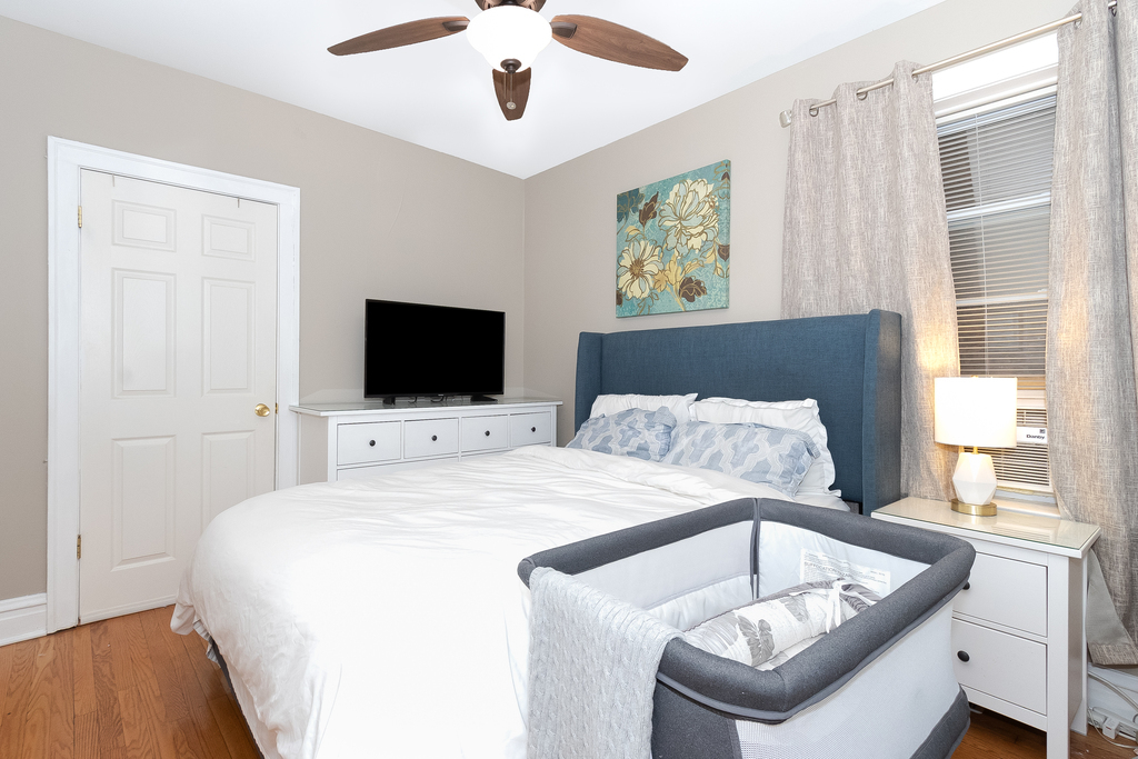 1234 Maple Avenue Berwyn, IL 60402 - Photo 11 of 25 a bedroom with a bed and a flat screen tv