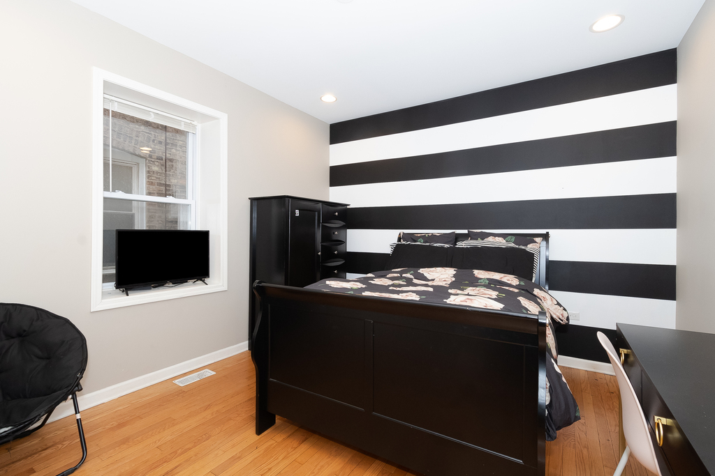 1234 Maple Avenue Berwyn, IL 60402 - Photo 13 of 25 a living room with a black furniture and a flat screen tv