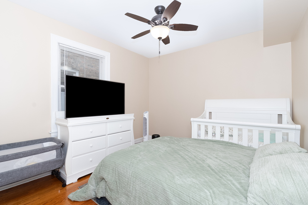 1234 Maple Avenue Berwyn, IL 60402 - Photo 20 of 25 a bedroom with a bed and a flat screen tv