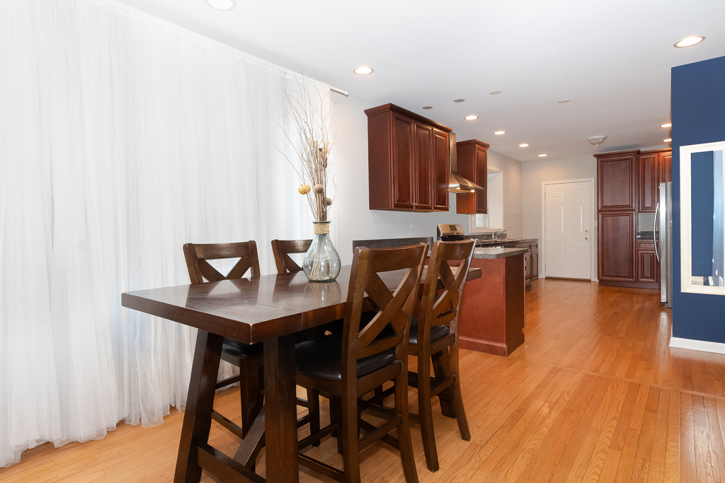 1234 Maple Avenue Berwyn, IL 60402 - Photo 6 of 25 a view of a dining room with furniture and wooden floor