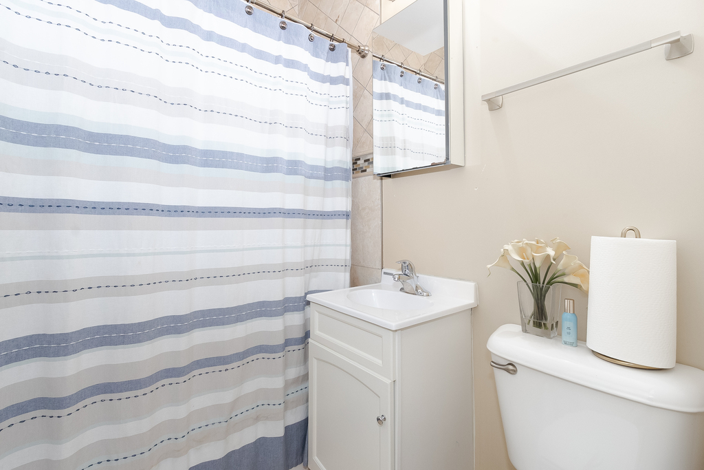 1234 Maple Avenue Berwyn, IL 60402 - Photo 9 of 25 a bathroom with a sink and a vanity