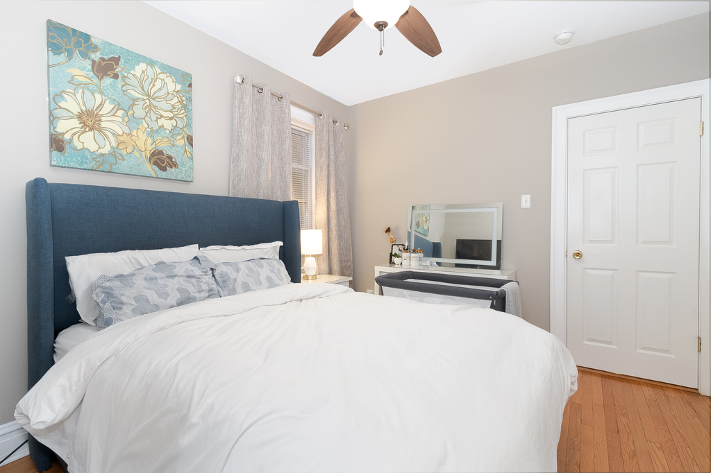 1234 Maple Avenue Berwyn, IL 60402 - Photo 10 of 25 a bedroom with a bed and a painting on the wall