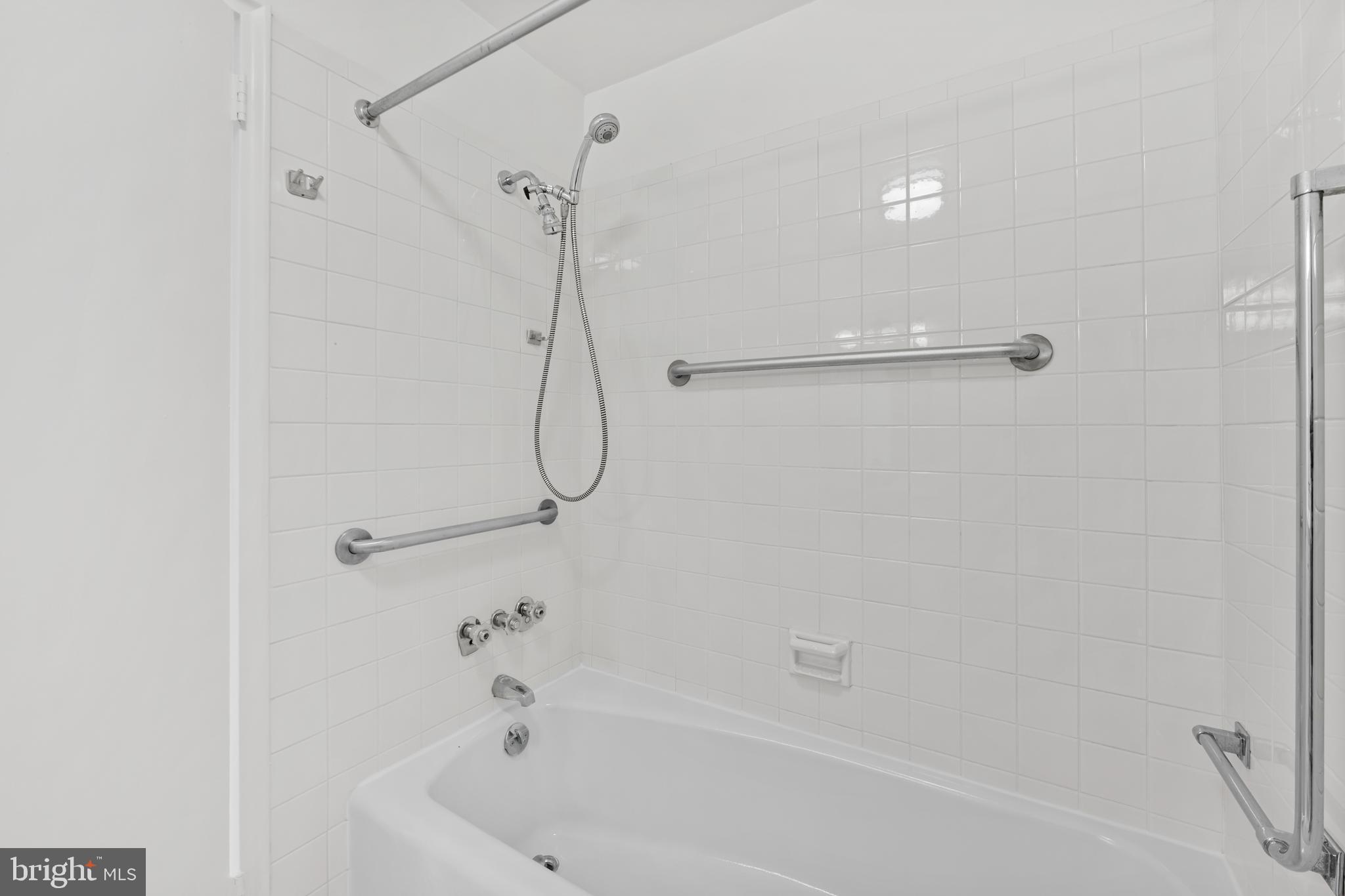11 Slade Avenue, Unit 911 Baltimore, MD 21208 - Photo 24 of 32 a bathroom with a bath tub with a shower