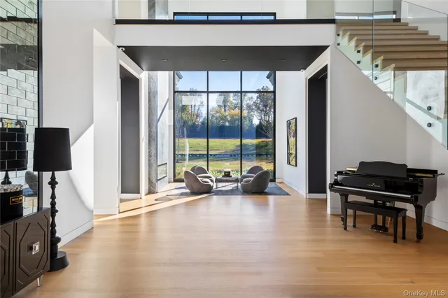 a kitchen with stainless steel appliances granite countertop a stove a sink dishwasher and white cabinets with wooden floor