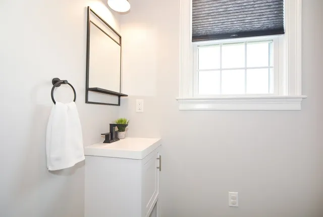 a bathroom with a sink and a window