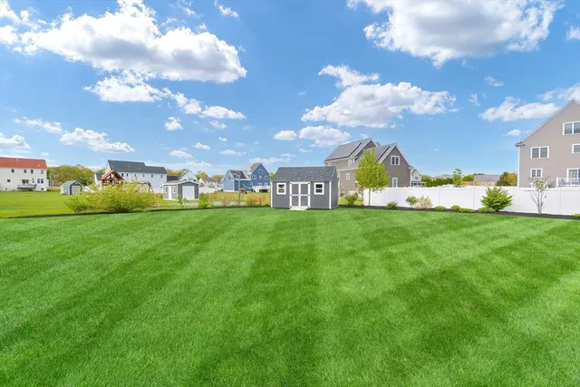 a view of a house with a yard and furniture