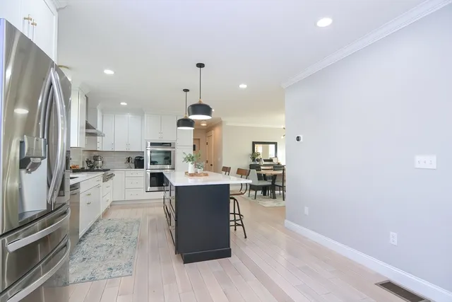 a view of kitchen with sink and refrigerator