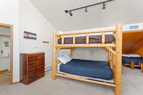 a bedroom with a bunk bed and a dresser