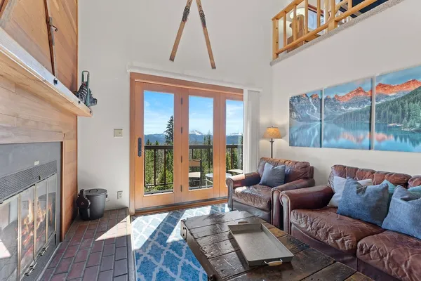 a living room with furniture and a floor to ceiling window