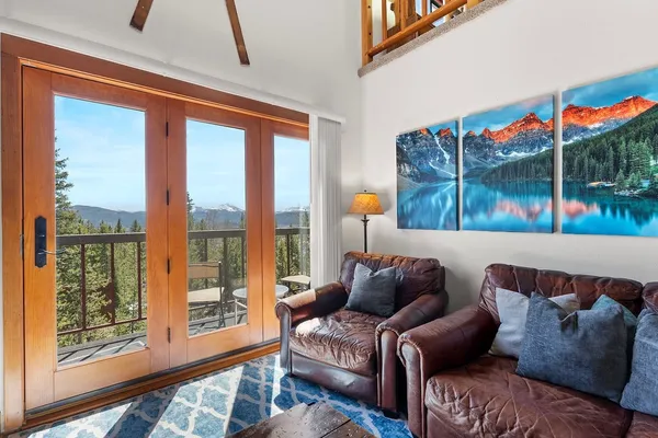 a living room with furniture and a floor to ceiling window
