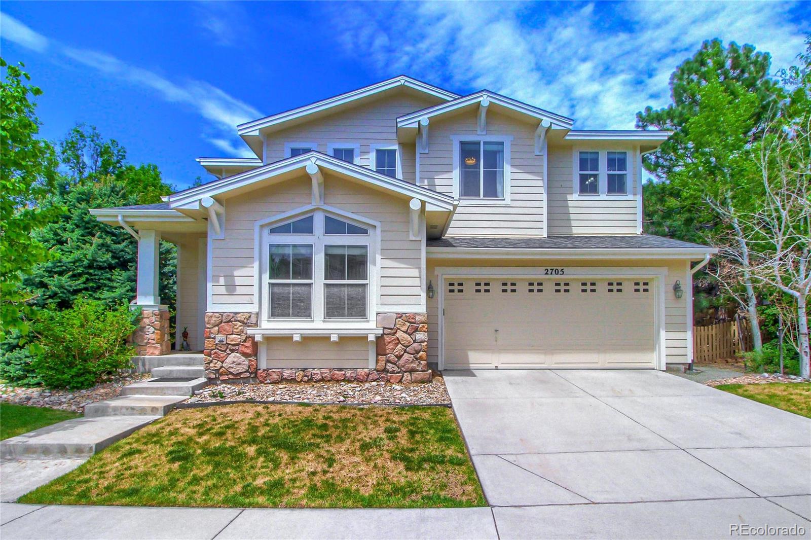 2705 Middlebury Drive Highlands Ranch, CO 80126 - Photo 1 of 40 a view of a house with small yard plants and large tree